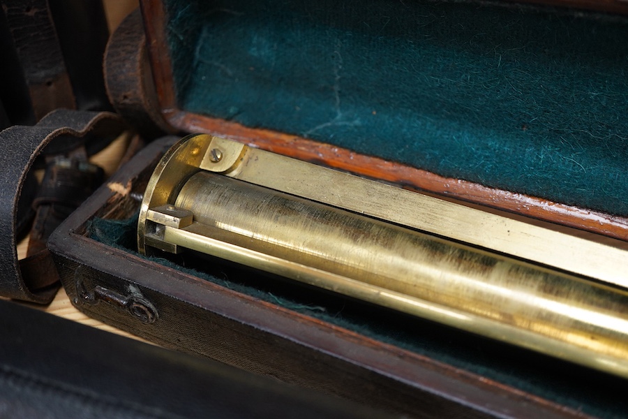 An early 20th century four draw brass telescope with leather grip, together with a brass table top tripod stand, both unmarked, both parts in separate fitted cases, the telescope fully extended 106cm, contracted 28cm